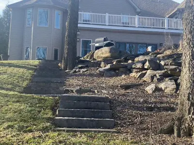 a house with a yard with some stairs in front of it at RiverFront Villa- Sleeps 11 in Lancaster