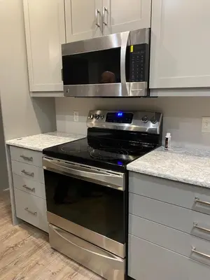 a kitchen with a stove and a microwave at RiverFront Villa- Sleeps 11 in Lancaster