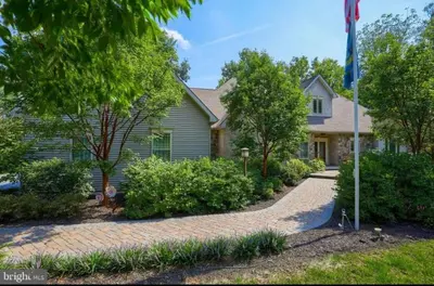 a house with a flag in front of it at RiverFront Villa- Sleeps 11 in Lancaster