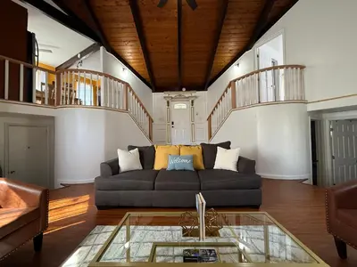 a living room with a couch and a glass table at Cozy Pocono Escape in Tobyhanna
