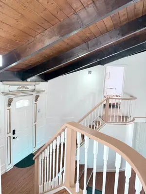 a staircase in a house with a wooden ceiling at Cozy Pocono Escape in Tobyhanna