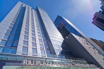 a tall building with a sign in front of it at Riu Plaza New York Times Square in New York