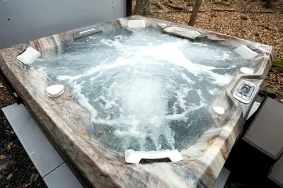a jacuzzi tub with water in it at Lake Cabin with Hot-Tub and Deck in Pennsylvania in Lake Ariel