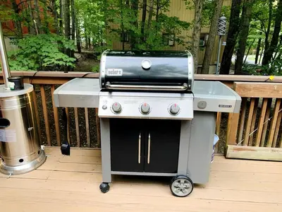 a grill sitting on a deck next to a porch at Lake Cabin with Hot-Tub and Deck in Pennsylvania in Lake Ariel
