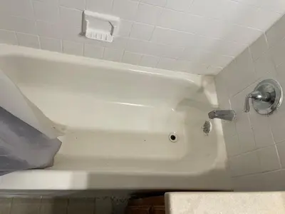 a white bath tub with a faucet in a bathroom at New Jersey Apt 1 bd in Edison