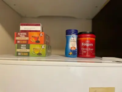 a shelf with two cans of spices and boxes at New Jersey Apt 1 bd in Edison