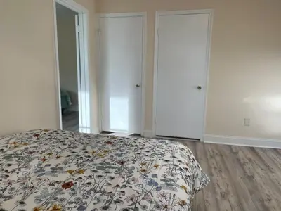 a bedroom with a bed with a floral bedspread at New Jersey Apt 1 bd in Edison