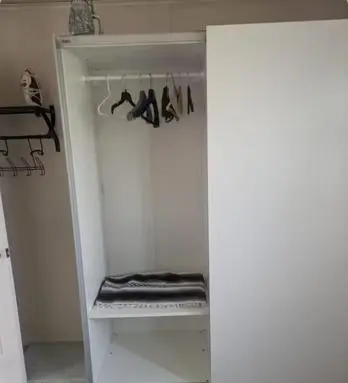a white closet with a shelf with shoes in it at The Zen Den in Hellertown