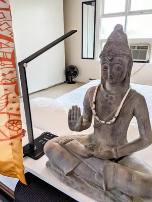 a statue sitting on a table next to a computer at The Zen Den in Hellertown