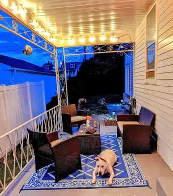 a dog laying on the porch of a house at The Zen Den in Hellertown