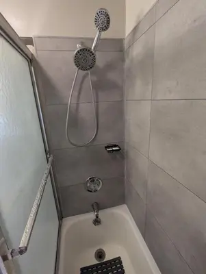 a shower with a shower head in a bathroom at The Zen Den in Hellertown