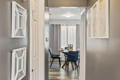 a hallway leading to a dining room with a table and chairs at Emerald Lakes Poconos Retreat Game Room, Firepit & Sleeps 10 in Long Pond