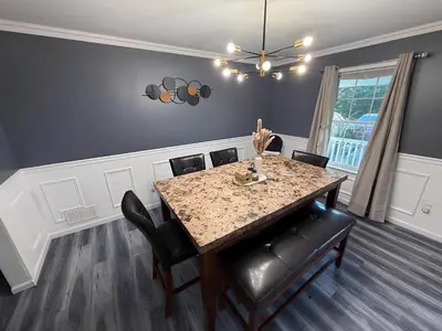 a dining room with a table and chairs at Emerald Lakes Poconos Retreat Game Room, Firepit & Sleeps 10 in Long Pond