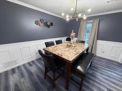 a dining room with a table and chairs at Emerald Lakes Poconos Retreat Game Room, Firepit & Sleeps 10 in Long Pond