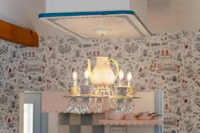 a chandelier hanging from a ceiling in a kitchen at Alice in Wonderland Pocono Home in Honesdale