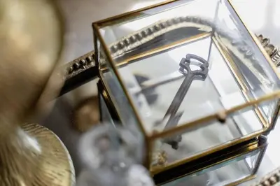 a close up of a clock in a glass case at Alice in Wonderland Pocono Home in Honesdale
