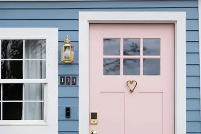 a blue house with a pink door and a window at Alice in Wonderland Pocono Home in Honesdale