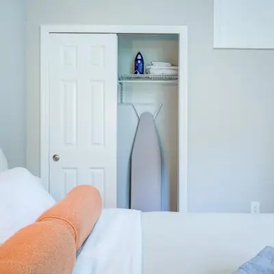 a bedroom with a white door and a mirror at Cozy 1BD With Balcony in Philadelphia