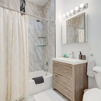 a bathroom with a shower and a sink and a toilet at Cozy 1BD With Balcony in Philadelphia