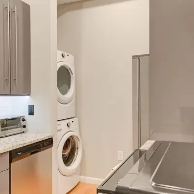 a kitchen with a washing machine and a washer and dryer at Cozy 1BD With Balcony in Philadelphia