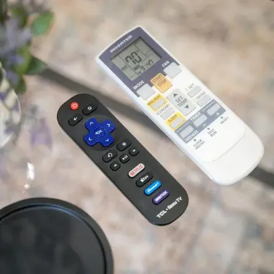 two remote controls sitting on top of a table at Cozy 1BD With Balcony in Philadelphia