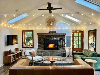 a living room with a couch and a fireplace at Stunning Catskills Cabin in Margaretville