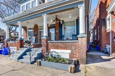 a brick house with a planter in front of it at 2 Mi to Dtwn Harrisburg Escape with Furnished Deck! in Harrisburg