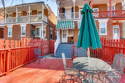 a patio with a table and an umbrella at 2 Mi to Dtwn Harrisburg Escape with Furnished Deck! in Harrisburg