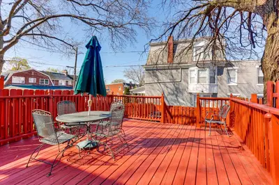 a patio with a table and chairs and an umbrella at 2 Mi to Dtwn Harrisburg Escape with Furnished Deck! in Harrisburg