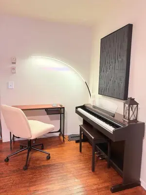 a piano in a room with a chair and a desk at Independence Day Best Fireworks View July 6 in Clifton