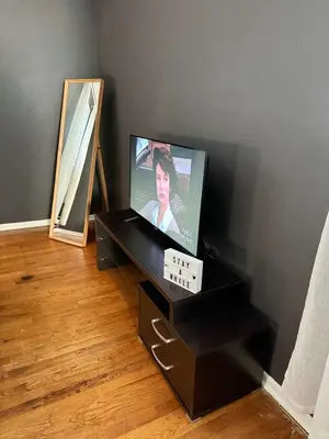 a television sitting on a black stand in a room at Independence Day Best Fireworks View July 6 in Clifton