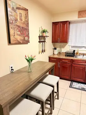 a kitchen with a wooden table and some chairs at Independence Day Best Fireworks View July 6 in Clifton