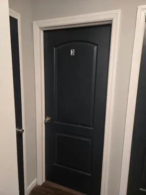 a black door with the letter b on it at favour family house in Newark