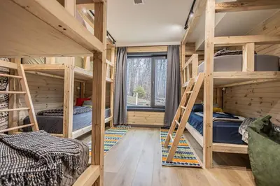a room with four bunk beds and a window at Luxury 6BR Mansion - Lakefront, Sauna, Hot Tub in Scotrun