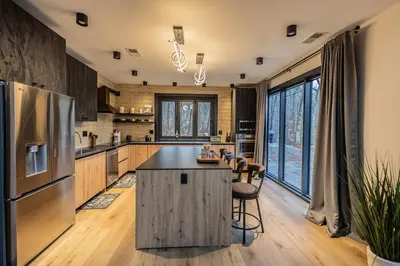 a kitchen with a large island with a counter top at Luxury 6BR Mansion - Lakefront, Sauna, Hot Tub in Scotrun