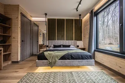 a bedroom with a bed and a large window at Luxury 6BR Mansion - Lakefront, Sauna, Hot Tub in Scotrun