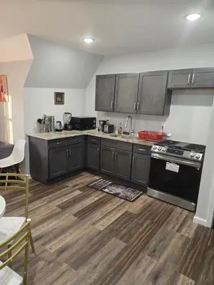 a kitchen with black appliances and wooden floors at Rose room 8 in Newark