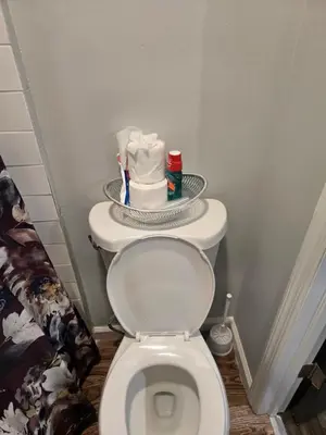 a bathroom with a toilet with a plate on top of it at Rose room 8 in Newark