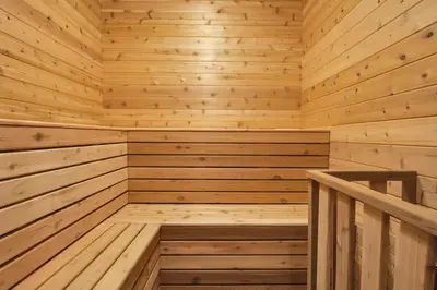 a wooden sauna with a wooden staircase in it at Log House Chalet, Volleyball field, Sauna, Hot Tub in Henryville
