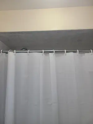 a curtain rod in a room with white curtains at Grace Room 4 in Newark