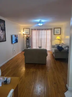 a living room with a couch and a table at Grace Room 4 in Newark