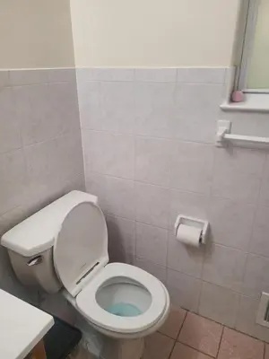 a bathroom with a toilet with the seat up at Grace Room 4 in Newark