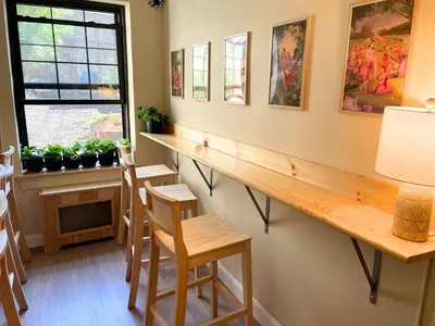 a bar with chairs and a table and a window at Interfaith 21st Street in New York