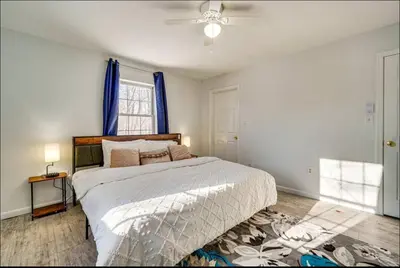 a bedroom with a bed and a ceiling fan at Newly renovated home, Fire pit, Games, Grill in Tobyhanna