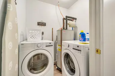 a laundry room with a washing machine and a washer at Newly renovated home, Fire pit, Games, Grill in Tobyhanna