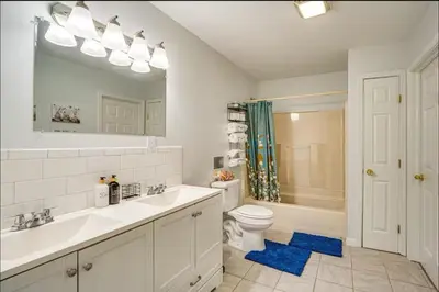 a bathroom with a sink and a toilet and a mirror at Newly renovated home, Fire pit, Games, Grill in Tobyhanna