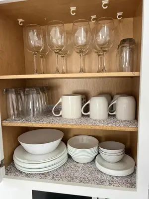 a cupboard filled with glasses and plates and bowls at Newly renovated home, Fire pit, Games, Grill in Tobyhanna