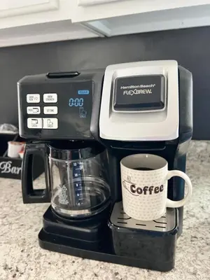 a coffee maker with a cup of coffee on a counter at Newly renovated home, Fire pit, Games, Grill in Tobyhanna