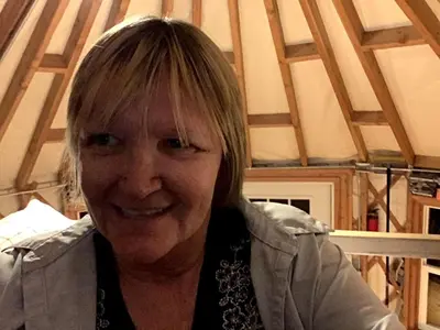 an older woman is smiling for the camera at Beautiful Yurt with Breathtaking Views in Livingston Manor, New York in Livingston Manor