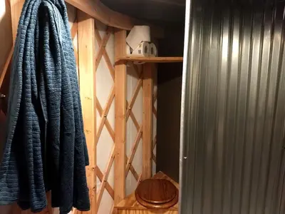a closet with a blue towel hanging on a wall at Beautiful Yurt with Breathtaking Views in Livingston Manor, New York in Livingston Manor